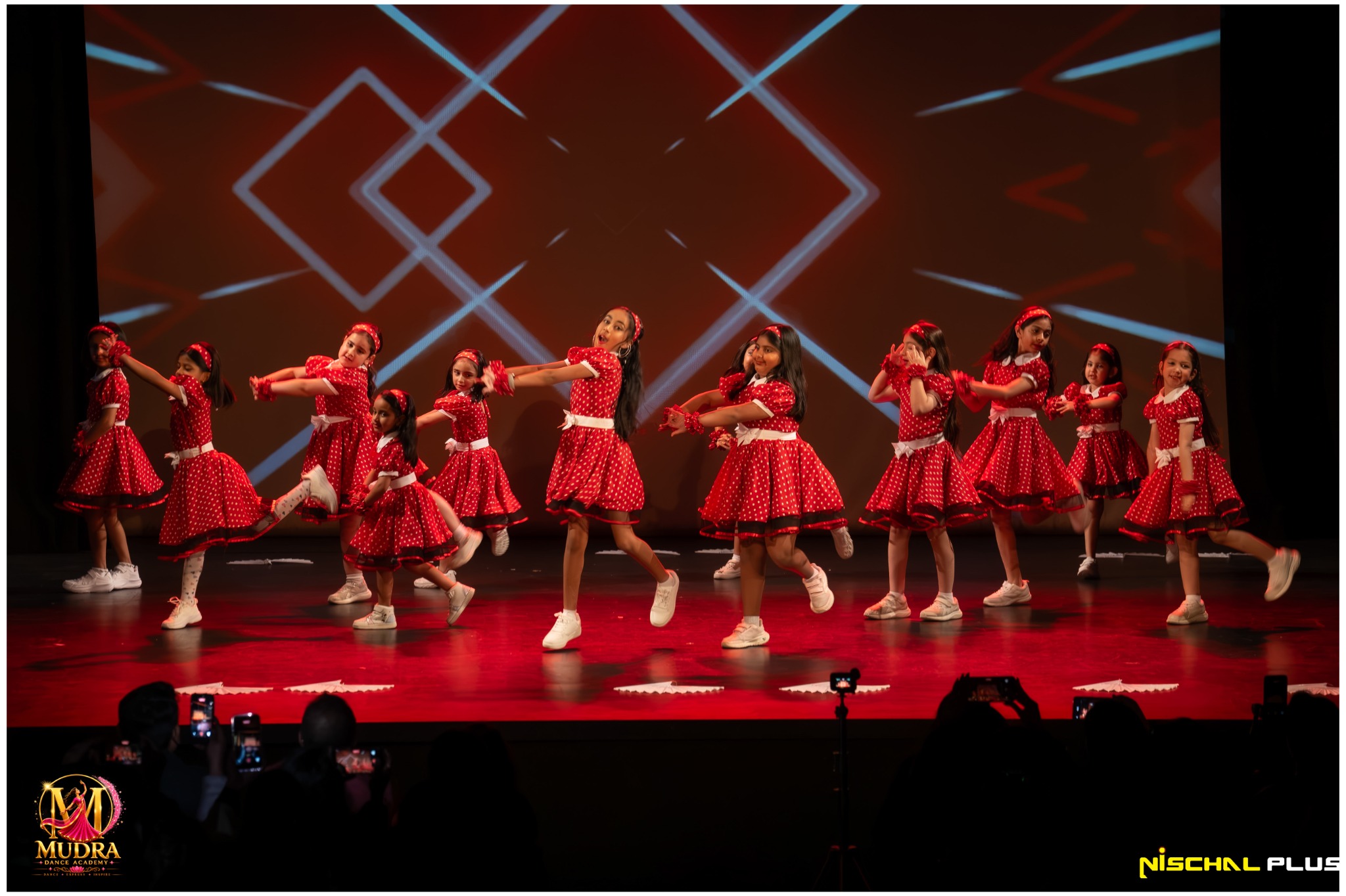 Mudra Dance Academy junior dancers performing together in red costumes