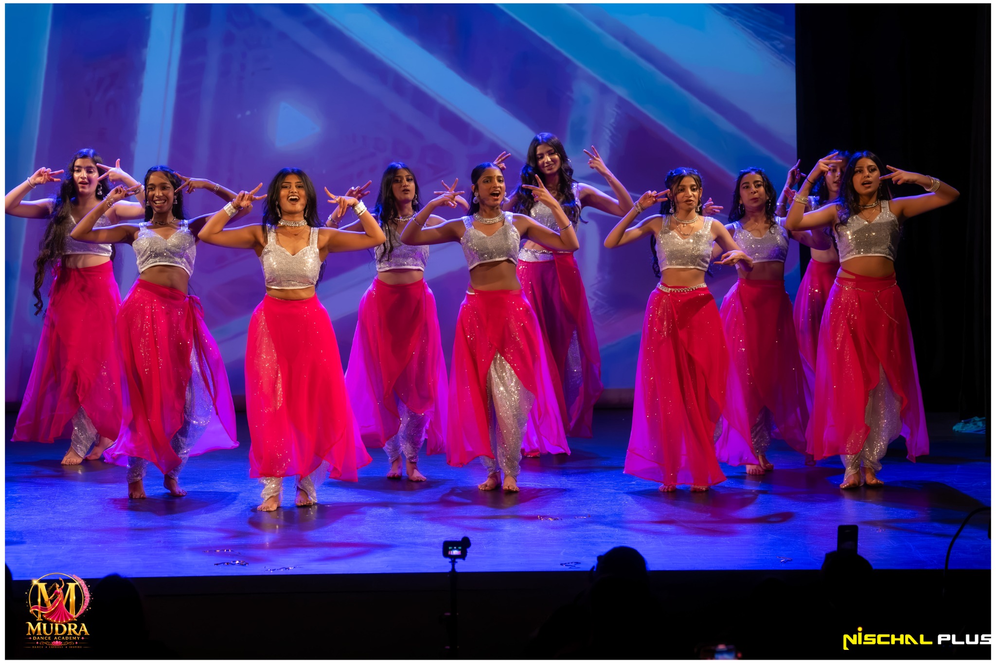 Mudra Dance Academy adult dancers performing in bright pink costumes