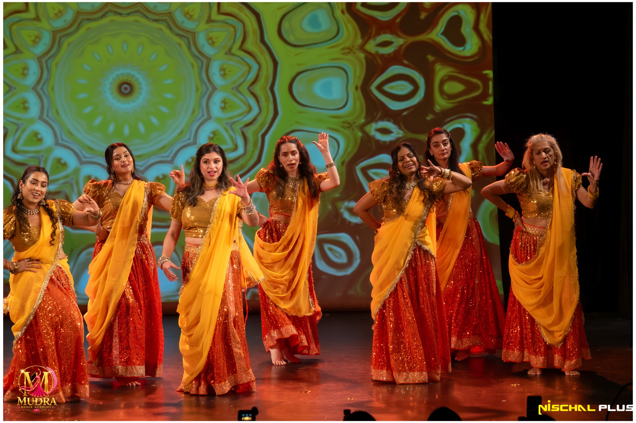 Mudra Dance Academy dancers celebrating Bollywood colour in orange costumes