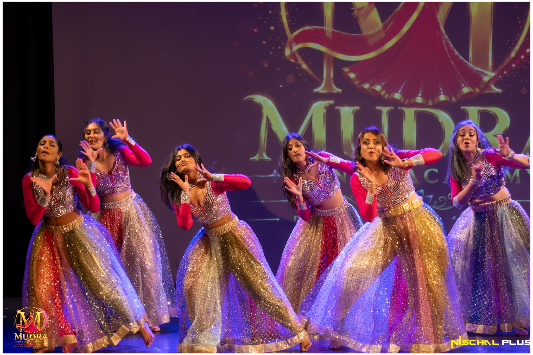 Mudra Dance Academy dancers performing in sparkling gold and silver costumes