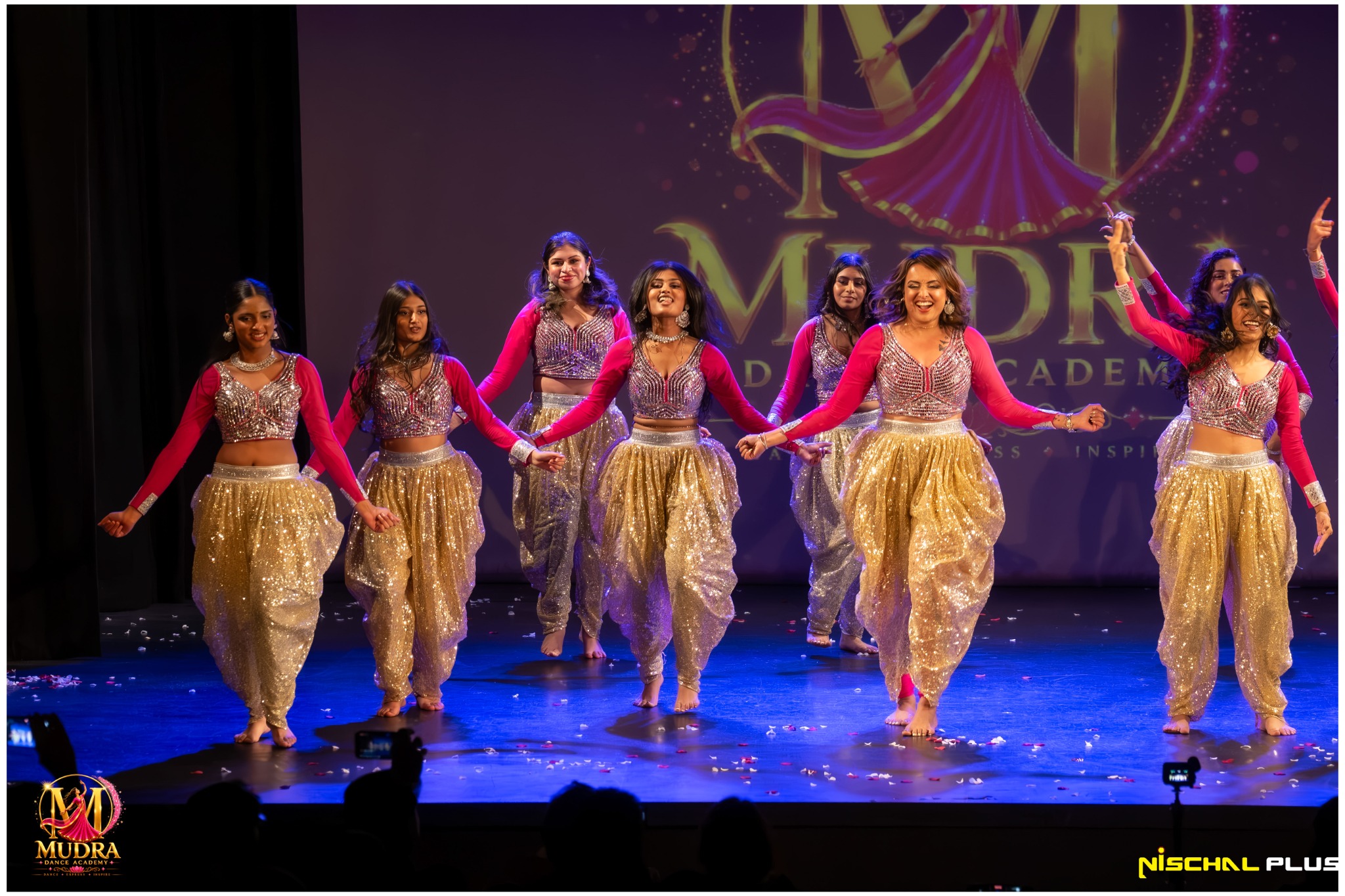 Mudra Dance Academy performance group finishing a vibrant stage routine